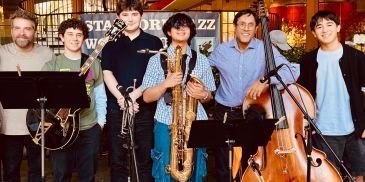 Group of smiling musicians with their instruments.