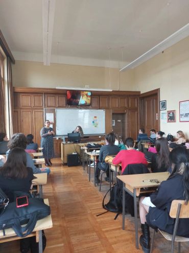 Classroom with teacher speaking to students.