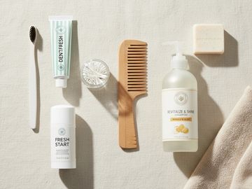 Natural personal care items arranged on a light fabric background.