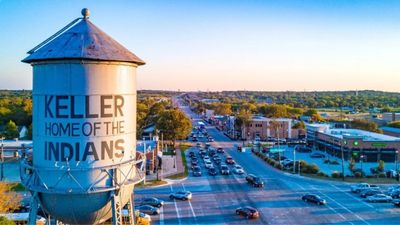 A water tower in Keller, Texas near a busy intersection.