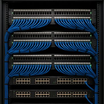 A neatly organized server rack with blue Ethernet cables.