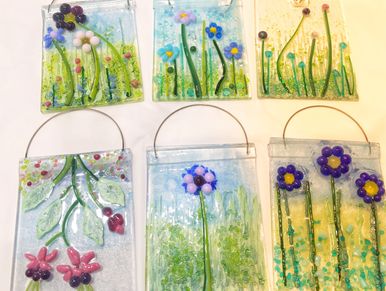 examples of floral glass panels made in a workshop. six glass panels with different flowers