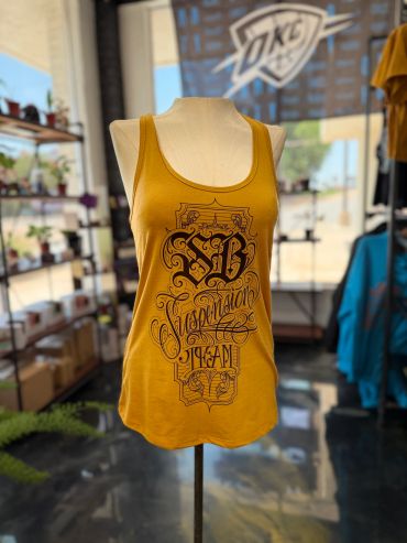 Yellow sleeveless top with intricate black lettering.