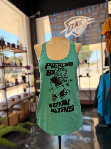 Green tank top with a piercing artist design on a mannequin.