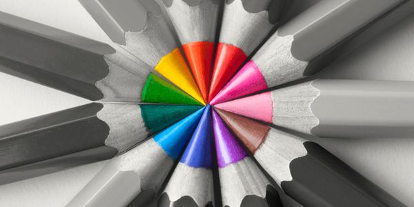 Colored pencil tips arranged in a circle with only the tips in color.