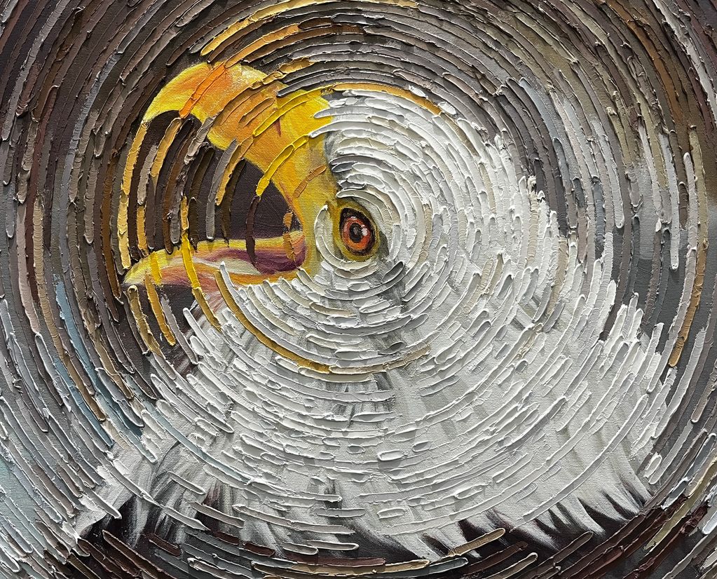Textured circular painting of an eagle's head.