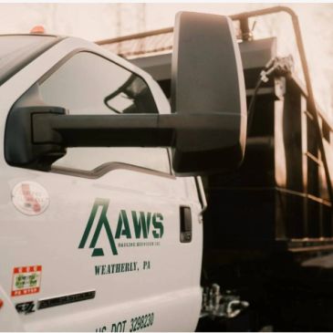Side view of a white truck with Aaws Hauling Services logo.