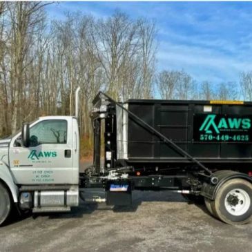 A white and black AWS service truck parked outside on a clear day.
