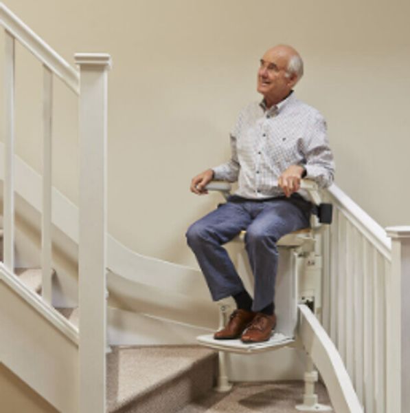 Elderly man sitting on a stairlift attached to a staircase.curved stair lifts
external stair lifts
straight stair lifts