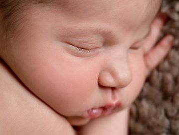 Close-up of a peacefully sleeping newborn baby.