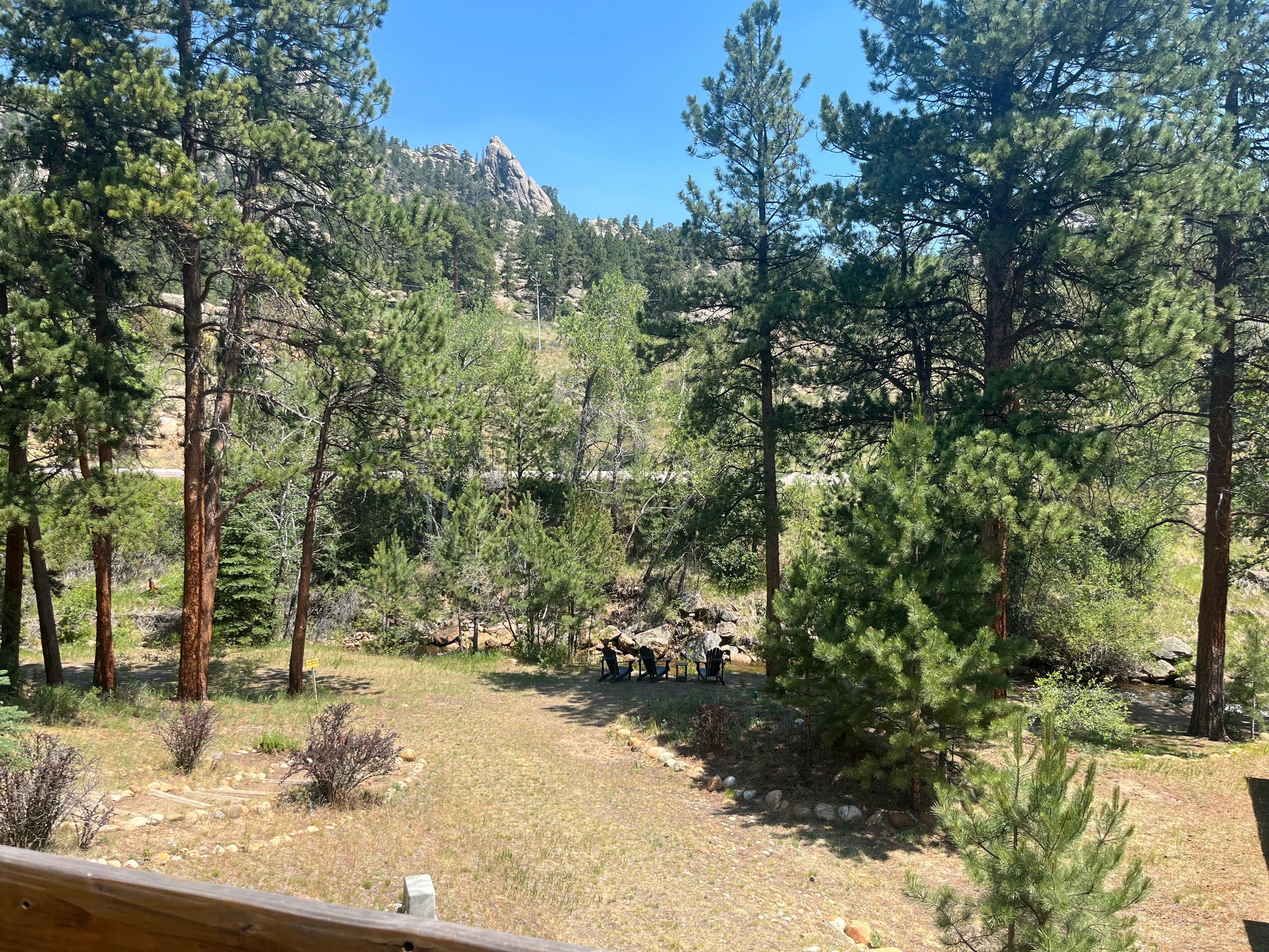 A scenic view of a mountainous landscape with trees and grassy areas.