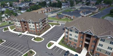 Aerial view of apartment complex showing buildings and parking of Westside Court.
