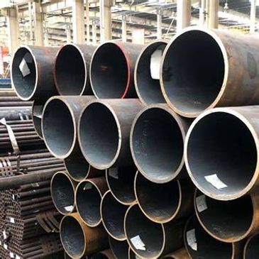 Stacked metal pipes in an industrial setting.