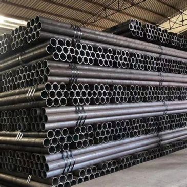 Stacked metal pipes in a warehouse.
