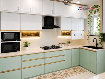 Modern kitchen with mint green cabinets and black appliances.