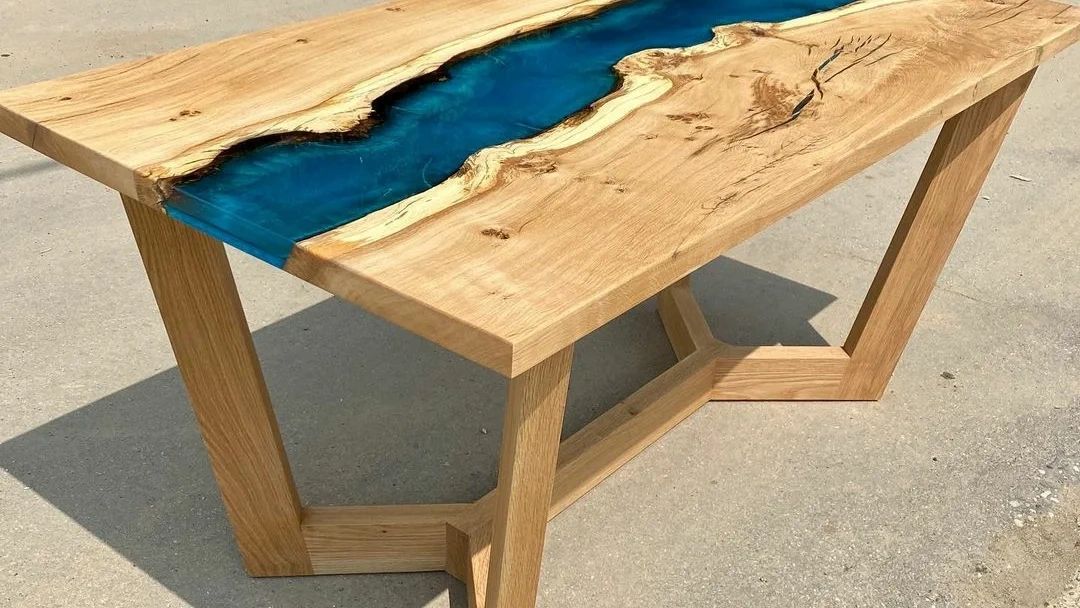 Wooden table with a blue resin river design.
