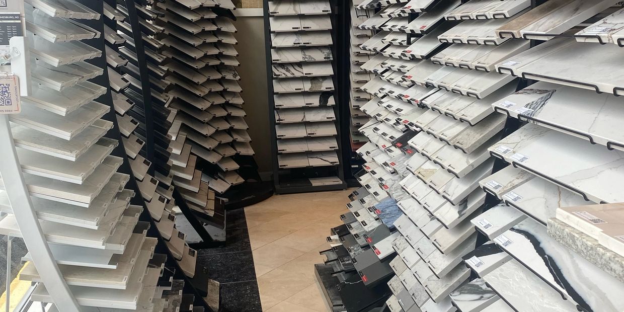 Display of various tile or stone samples in a showroom.