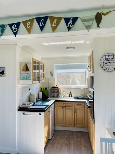 Cozy kitchen with wooden cabinets and beach-themed decor.