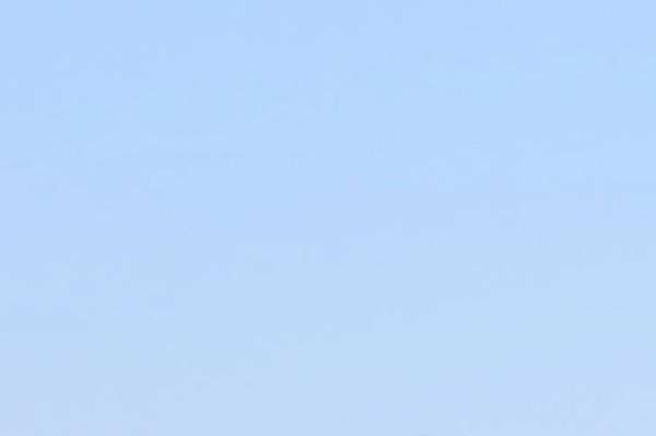 Clear blue sky with a few scattered clouds.