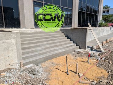 Newly constructed concrete stairs outside a commercial building under construction.