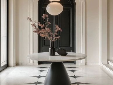 Elegant round table with a black vase and minimal decor in a stylish modern hallway.