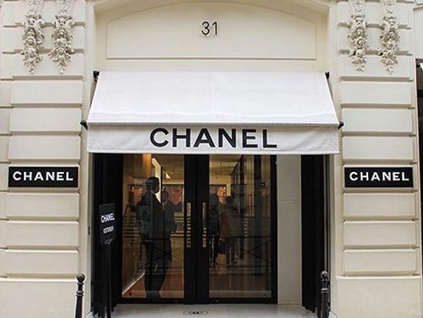 Chanel storefront with black and white signage and awning.