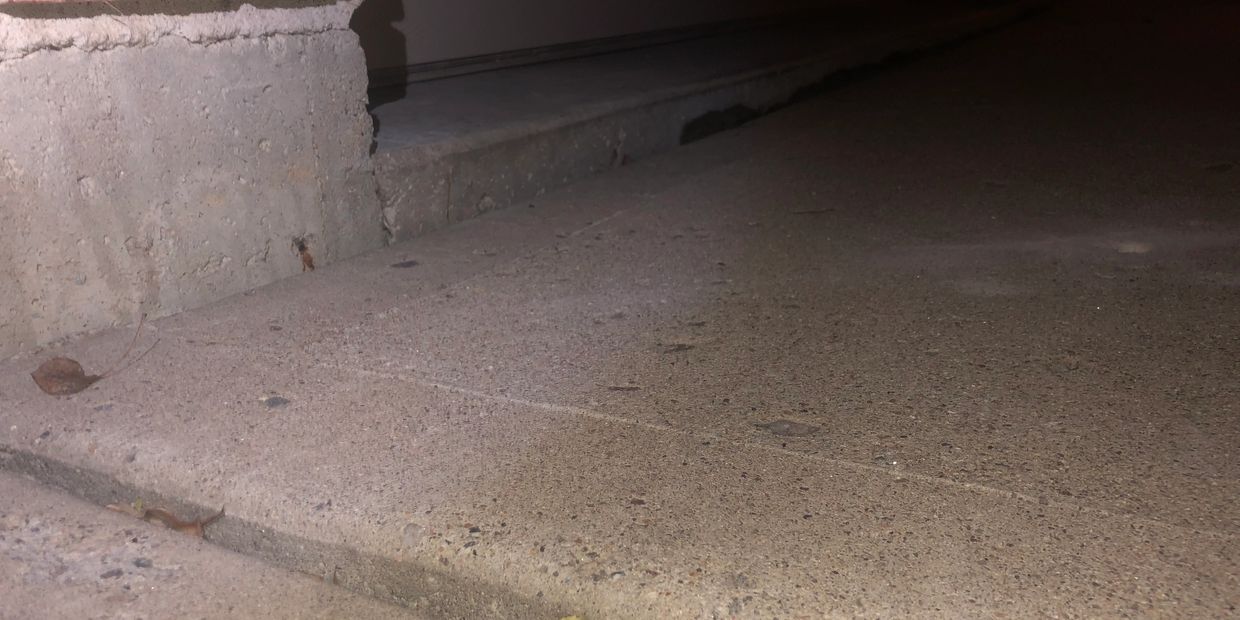 Concrete that has settled more than 1.5 inches.