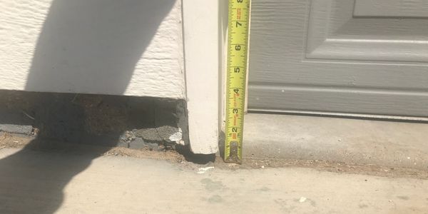 Concrete that has settled more than 1.5 inches, that has now become a tripping hazard.