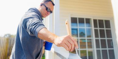 painting exterior of home with white paint handyman service