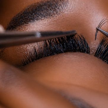 Close-up of eyelash extensions being applied with precision.