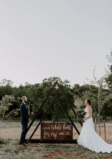 bride and groom standing at a distance from each other 