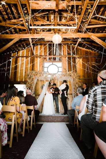 Bride, groom, marriage officiant, and guests 