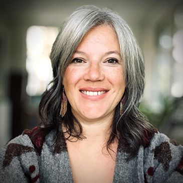 Portrait of Tanya Brunel, a Métis woman from the Red River region in Manitoba, smiling warmly.