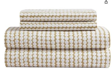 Stack of beige and white patterned bed sheets.