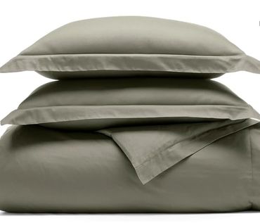 Green bedding set with pillowcases and sheets.