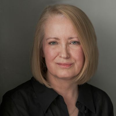 Portrait of a middle-aged woman with blonde hair and a calm expression.