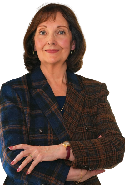 Confident woman in a stylish plaid blazer with arms crossed.