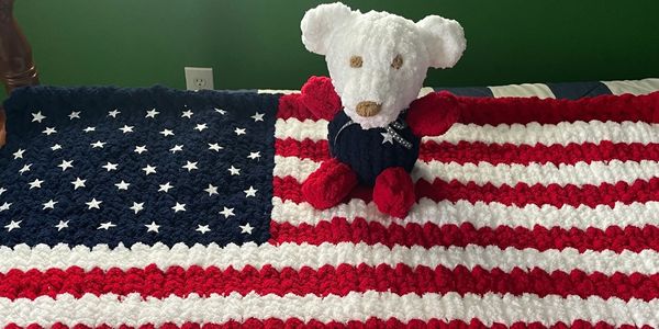 An American Flag throw with a matching teddy bear
God Bless the USA