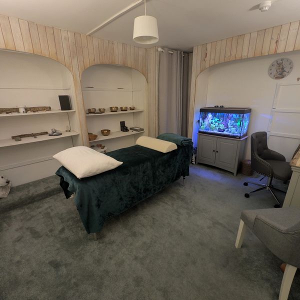 Cozy energy healing room with soft lighting and fish tank. Truro Energy Healing, Cornwall