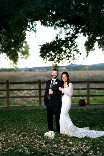 Happy bride and groom posing outdoors.