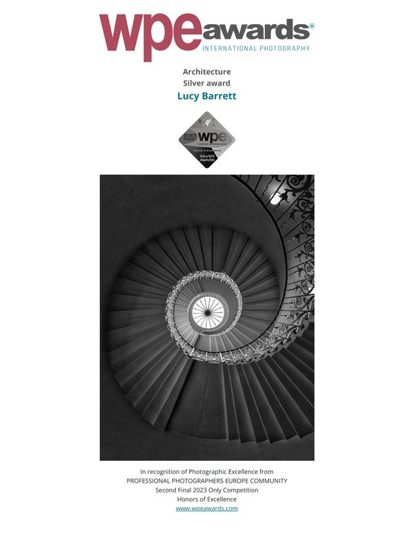 Spiral staircase captured in black and white, awarded by WPE for architectural excellence.