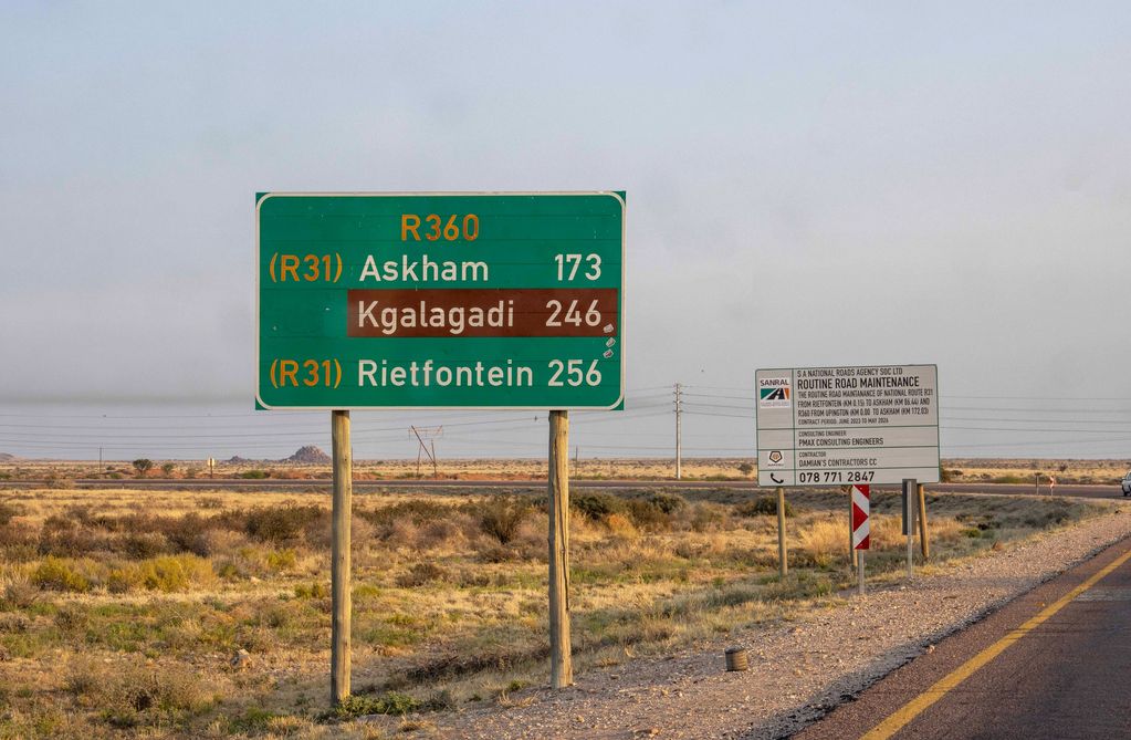 Road signs showing distances to Askham, Kgalagadi, and Rietfontein in a dry landscape.