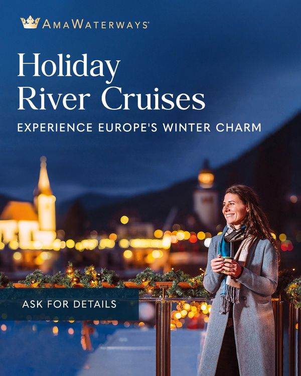 Woman enjoying a winter river cruise with festive lights and a warm drink.