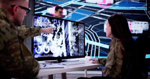 Soldiers collaborating on digital display