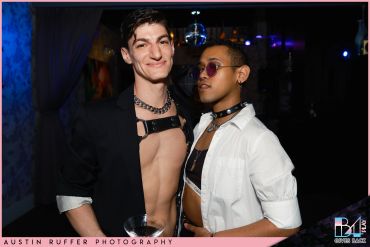 Two stylish men posing confidently in edgy club attire at a nightlife event.