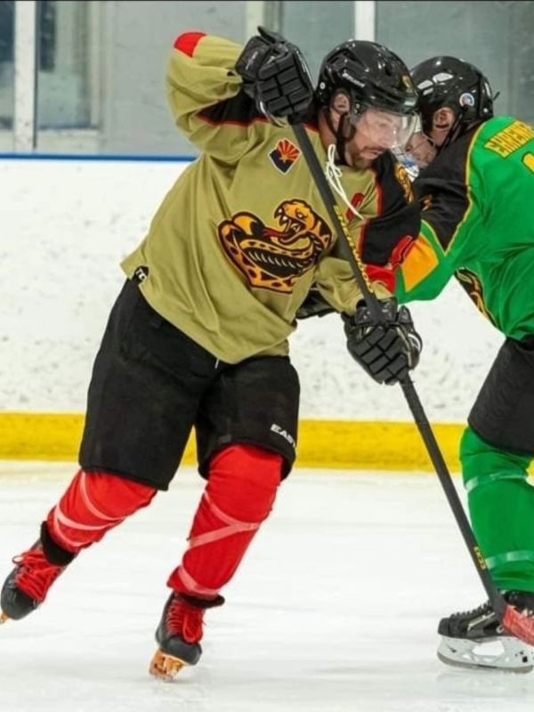 Two ice hockey players competing on the ice rink.