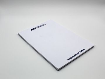 A white notepad with 'Keeping Britain Trading' text.
