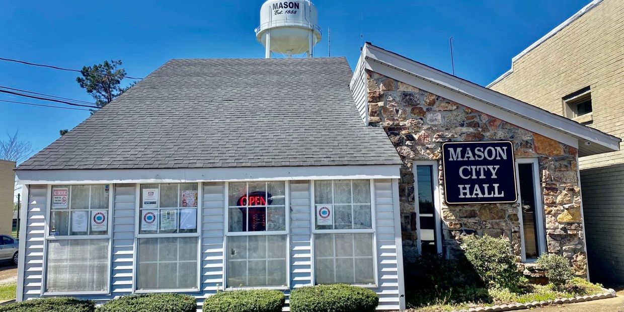Mason City Hall with water tower on a clear day in Mason, Tipton County, Tennessee.