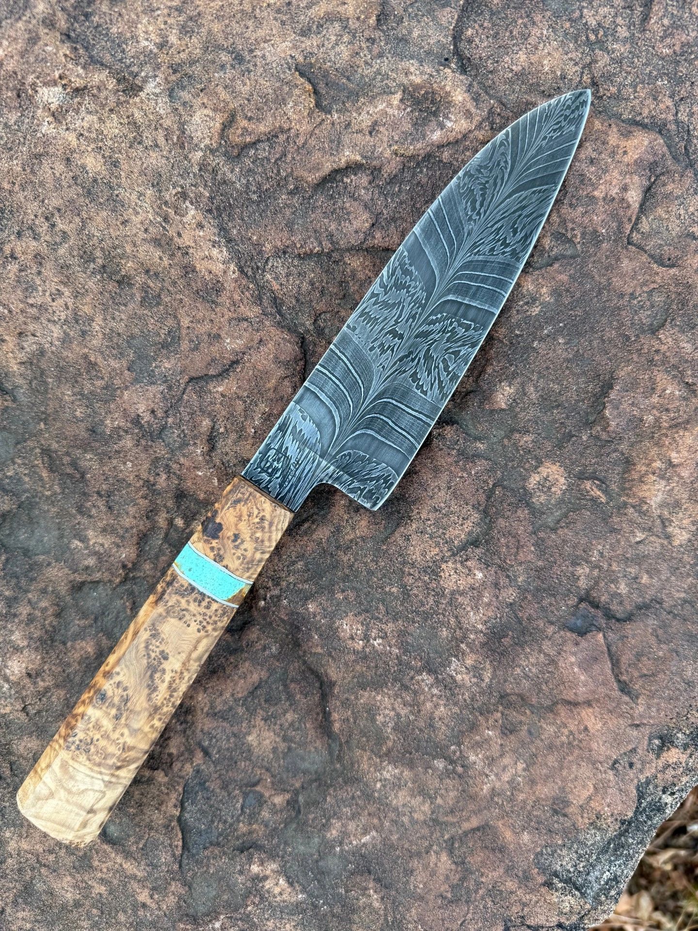 Stunning pattern on this wood-handled Damascus chef knife.

