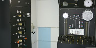 Large black anodised control panels for a decompression chamber.